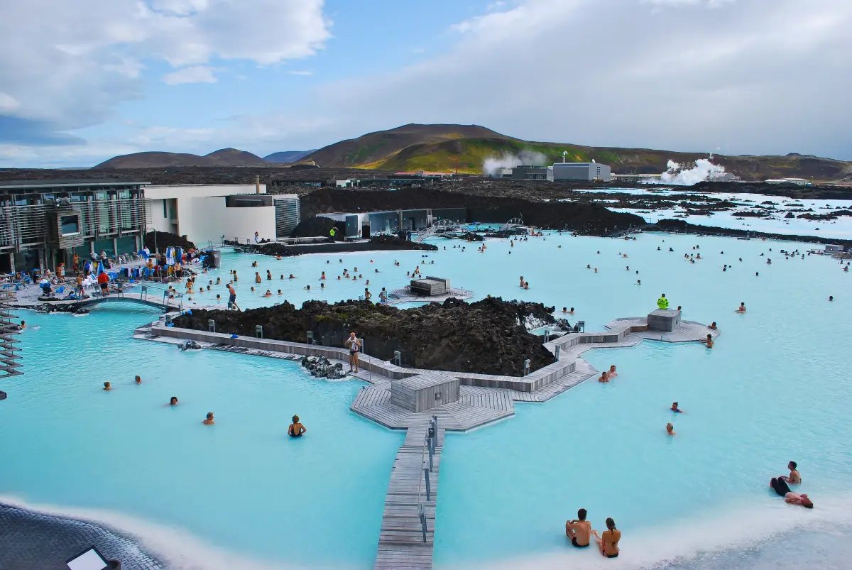 Steaming mineral-blue geothermal lagoon surrounded by dark lava fields at the Blue Lagoon, Reykjanes, Iceland