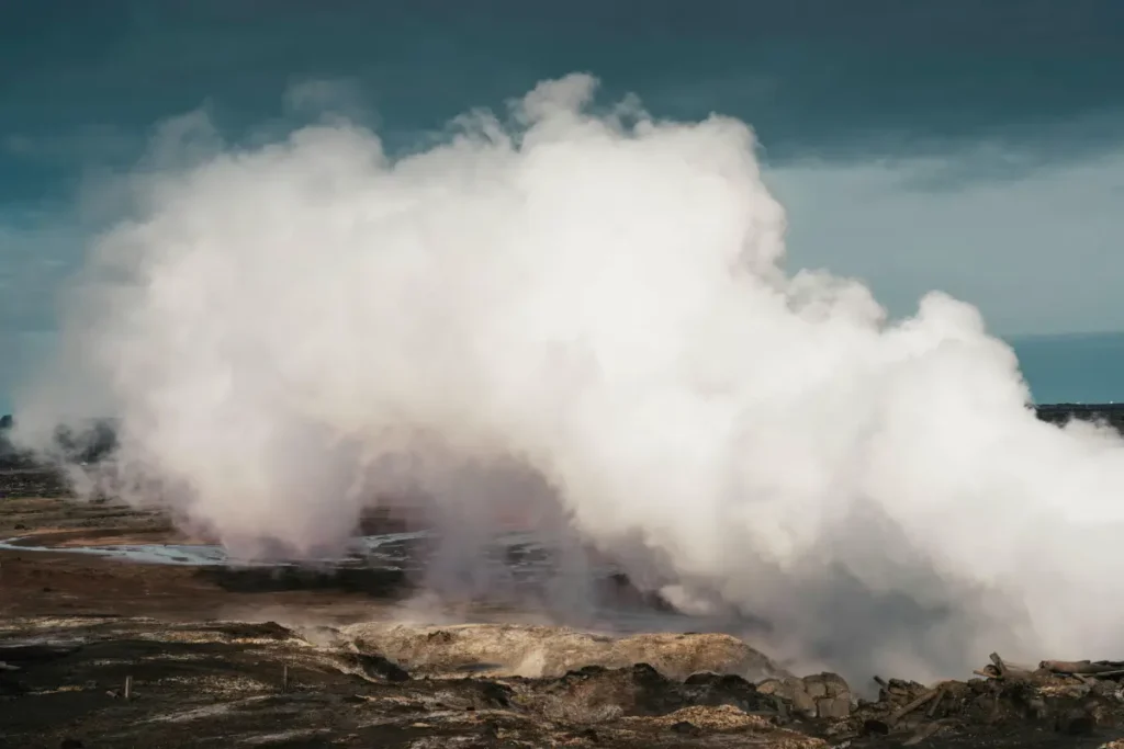 Steam rising from geothermal ground in an Icelandic volcanic area