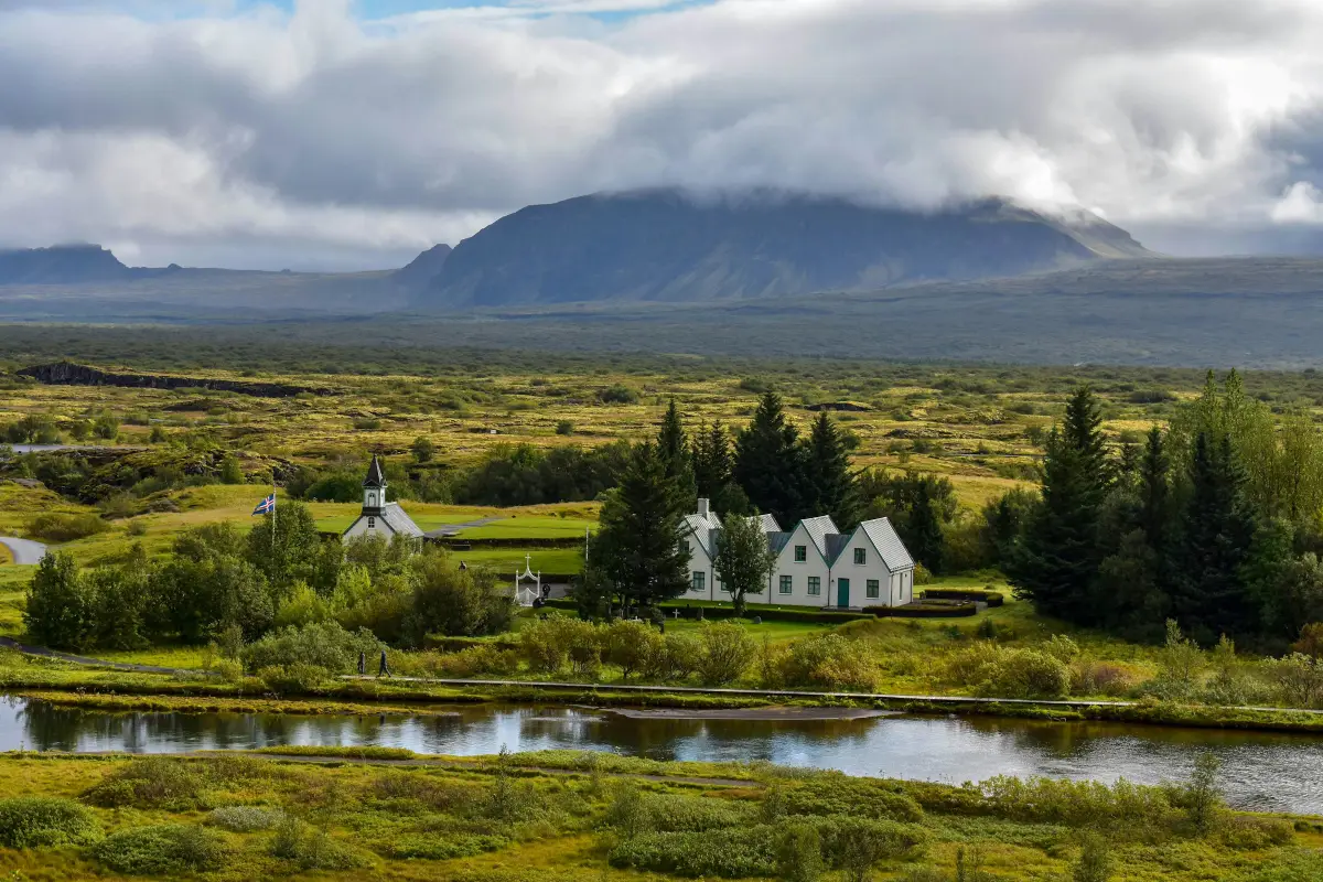 Þingvellir church surrounded by lush fields and mountains in Þingvellir National Park, Iceland