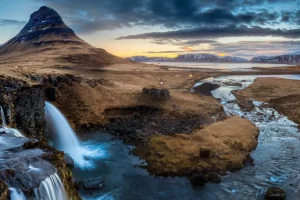 Kirkjufell mountain and Kirkjufellsfoss waterfall at sunset in Iceland