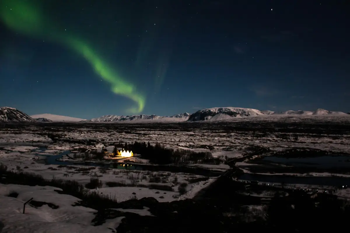 Aurora borealis over Þingvellir National Park and its church on a winter night