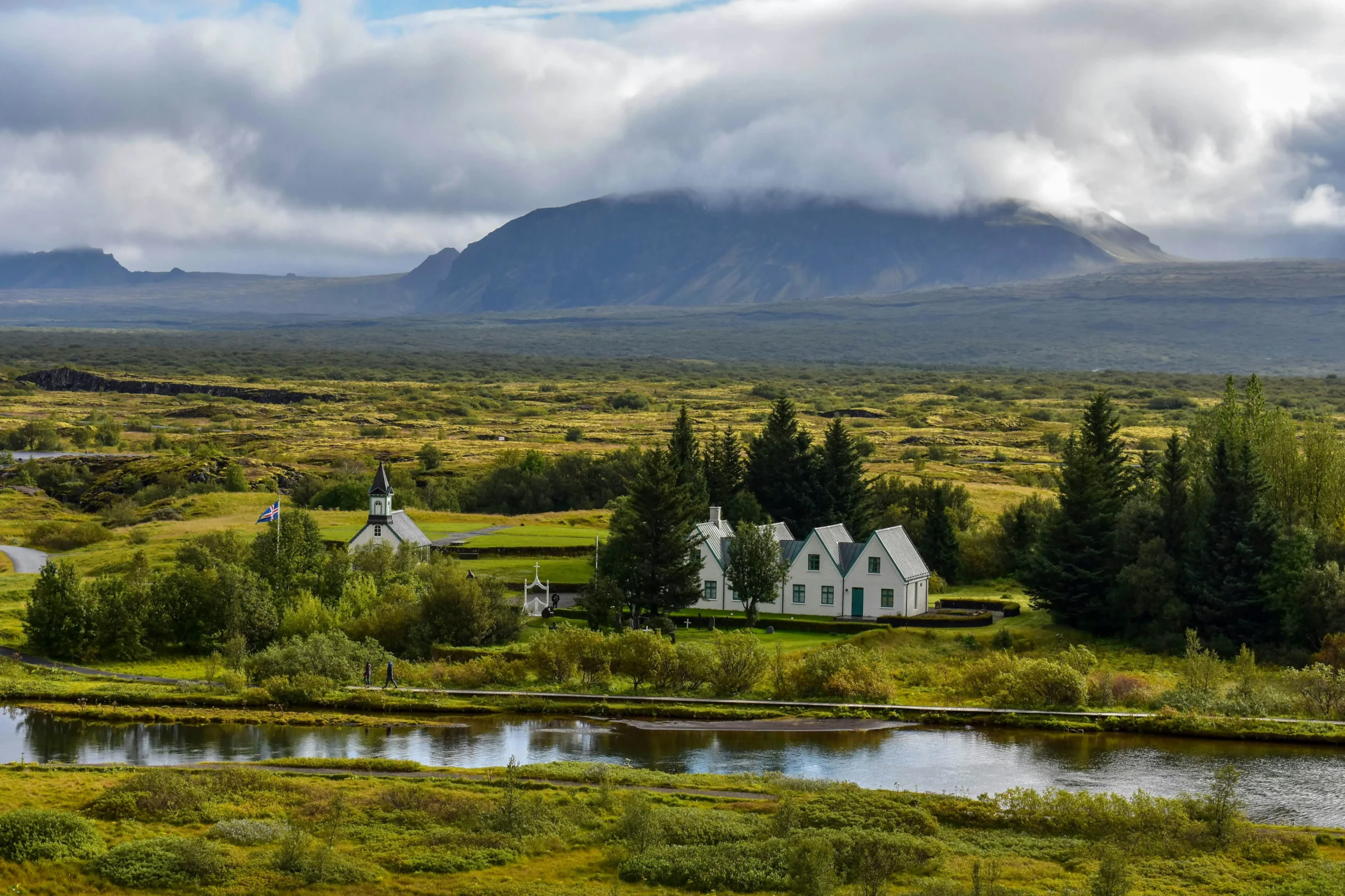 Þingvellir church surrounded by lush fields and mountains in Þingvellir National Park