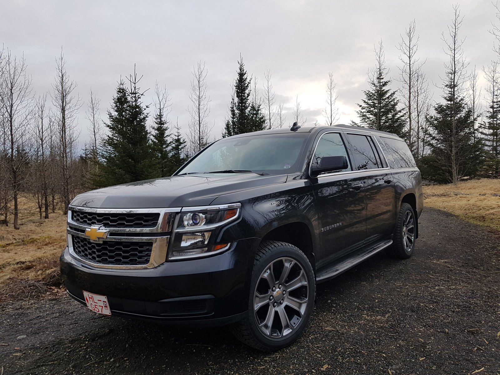 Private tour vehicle parked on a gravel road surrounded by Icelandic countryside