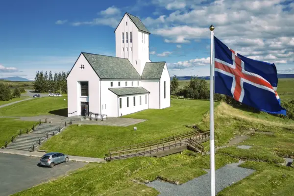 Skálholt Cathedral with Icelandic flag in the foreground