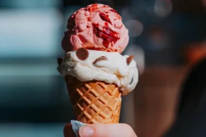 Ice cream cone with strawberry and vanilla scoops from Efstidalur farm in Iceland