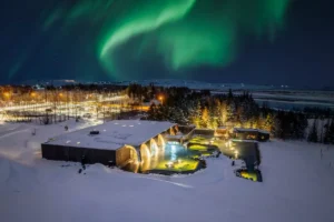 Northern Lights above Laugarás Lagoon geothermal spa in winter, Iceland