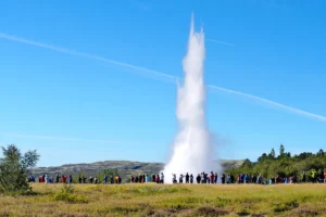 Strokkur geyser erupting with a tall water plume in the Geysir geothermal area in Iceland
