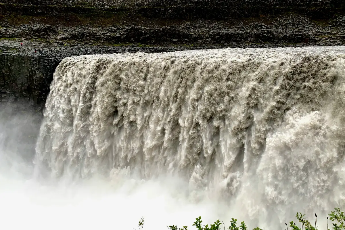 Close-up of Dettifoss waterfall with powerful white water plunging over a dark canyon edge