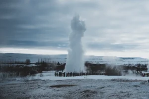 Strokkur geyser erupting in winter at the Geysir Geothermal Area on the Golden Circle