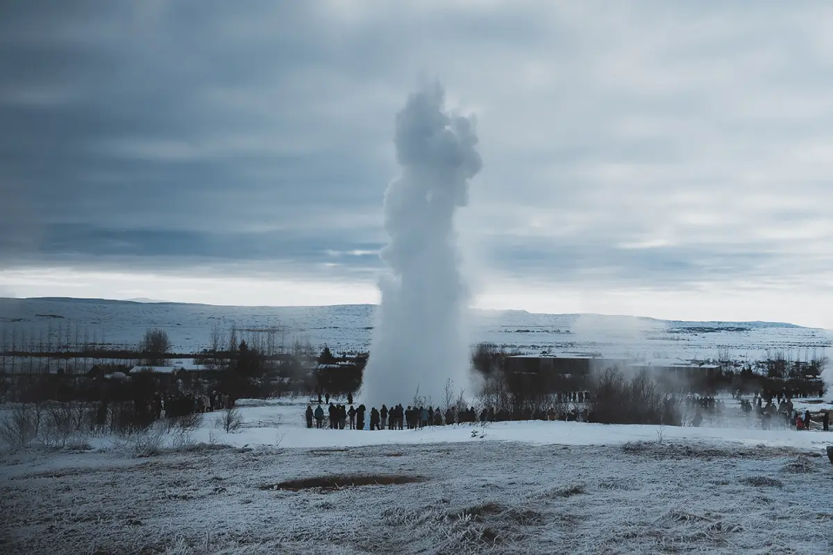 Strokkur geyser erupting in winter at the Geysir Geothermal Area on the Golden Circle