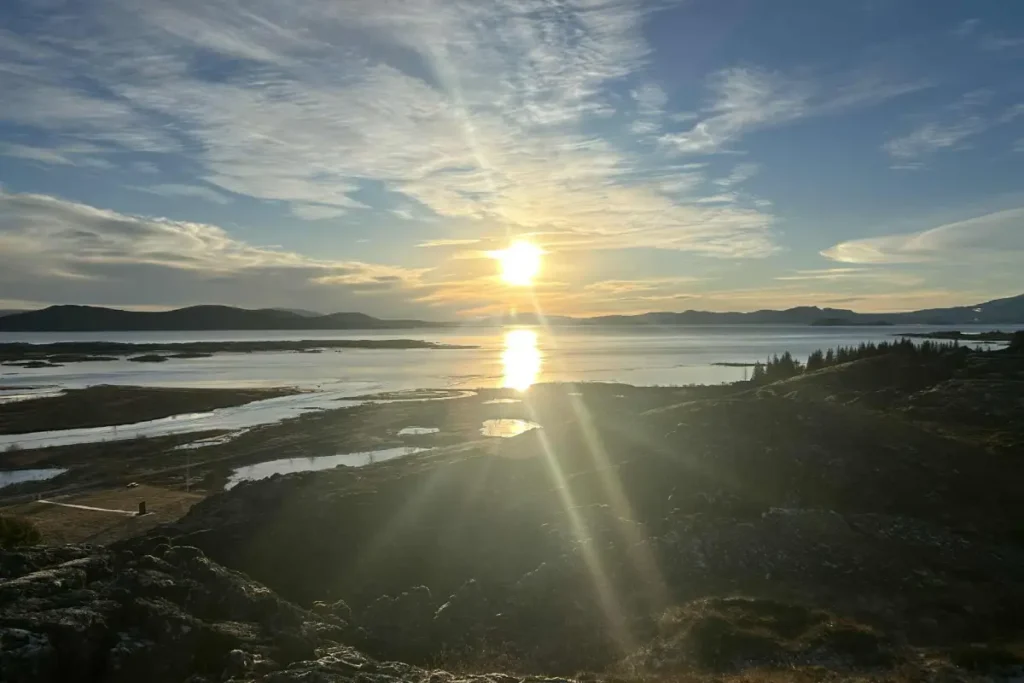 View over Þingvallavatn lake in Þingvellir National Park, Iceland, with water channels, volcanic landscape, and evening sunlight