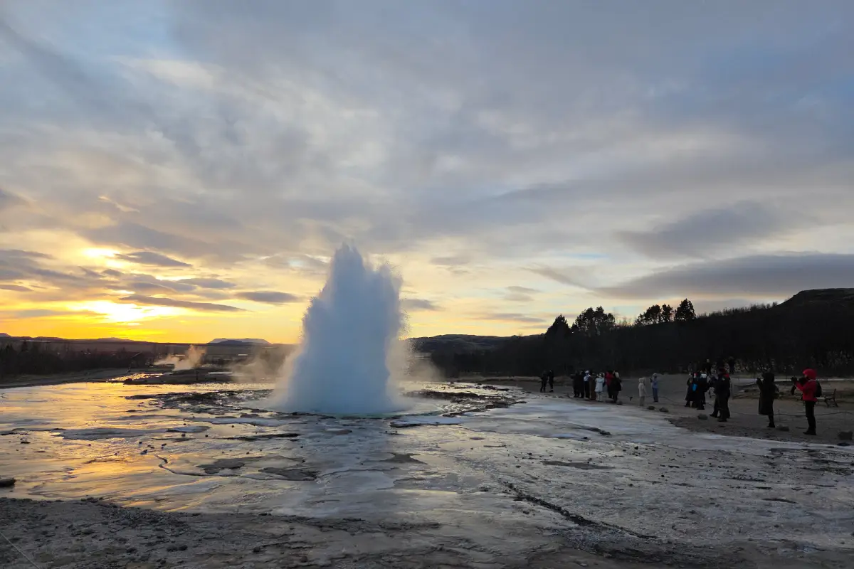 Geysir erupting at sunset on the Golden Circle