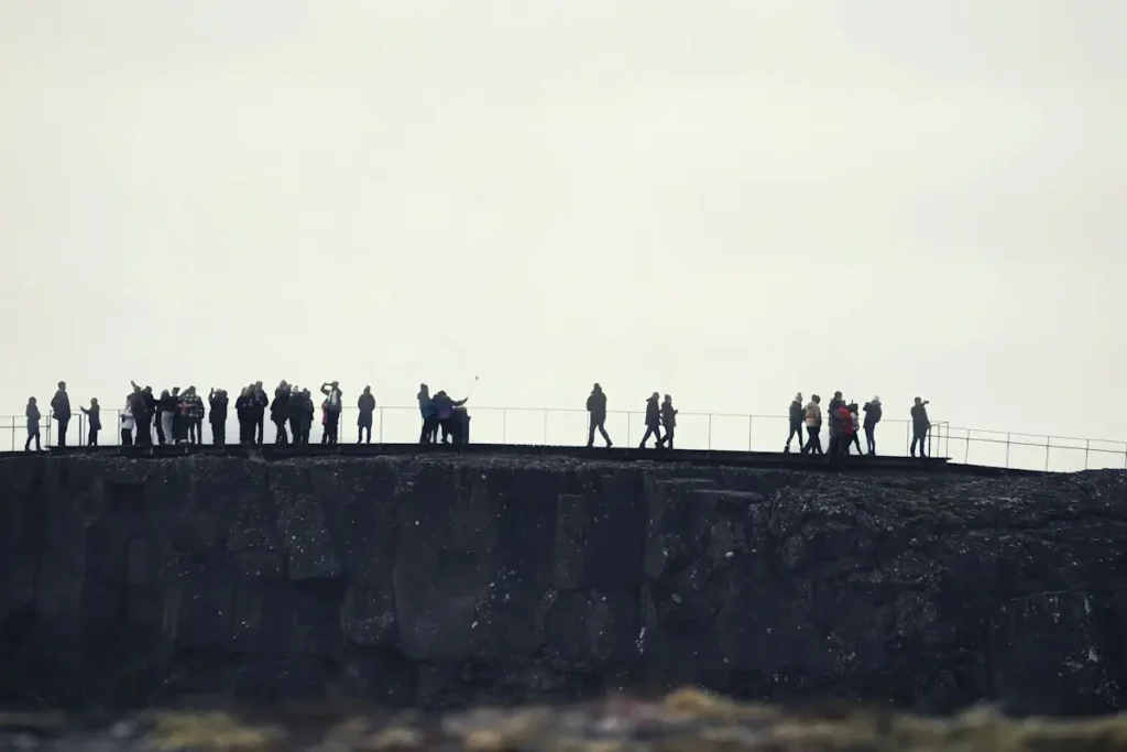 Visitors standing at the viewing platform in Þingvellir National Park