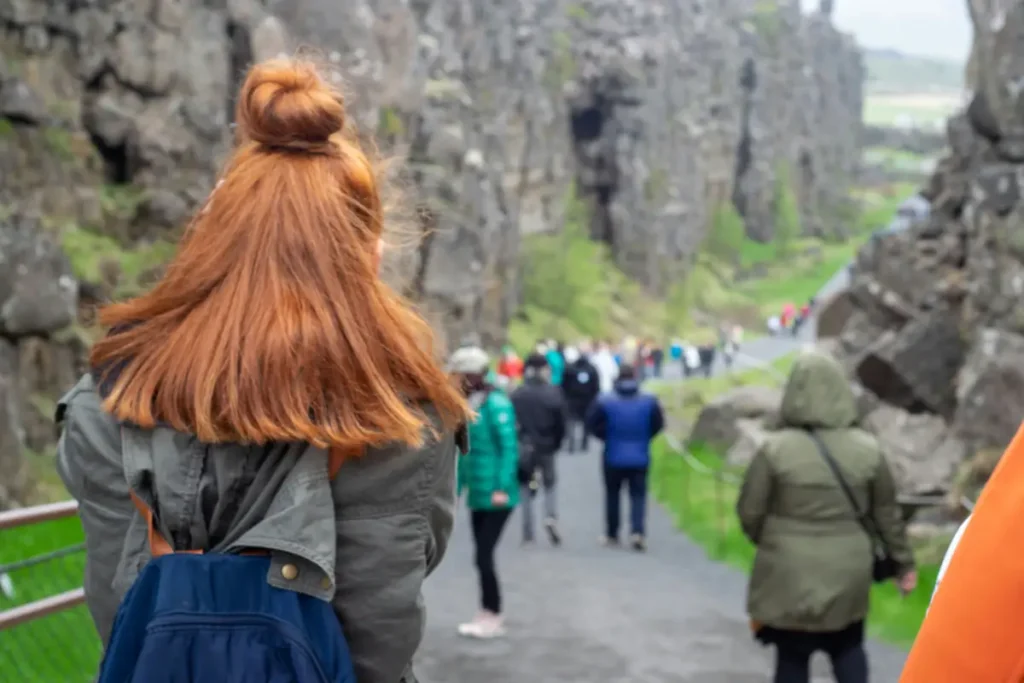 Travelers walking through Almannagjá gorge at Þingvellir National Park