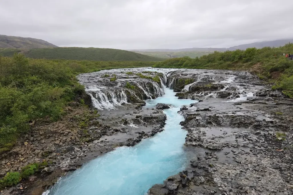 Wide view of Brúarfoss waterfall and blue river in South Iceland
