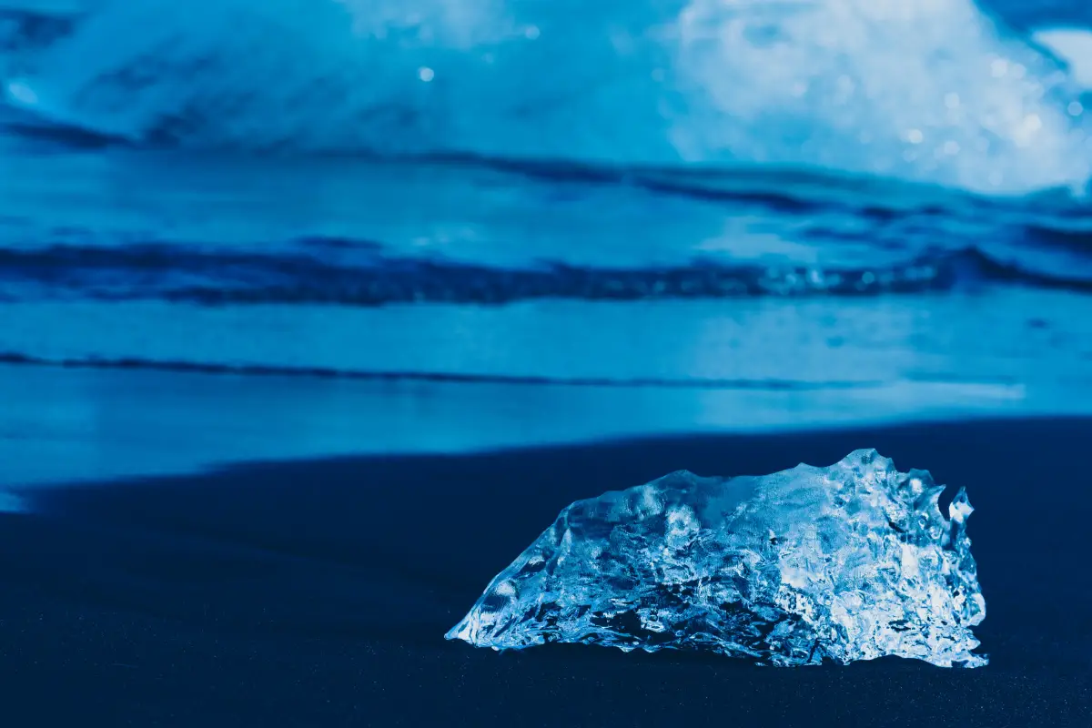Pieces of glacial ice resting on the black sand of Diamond Beach